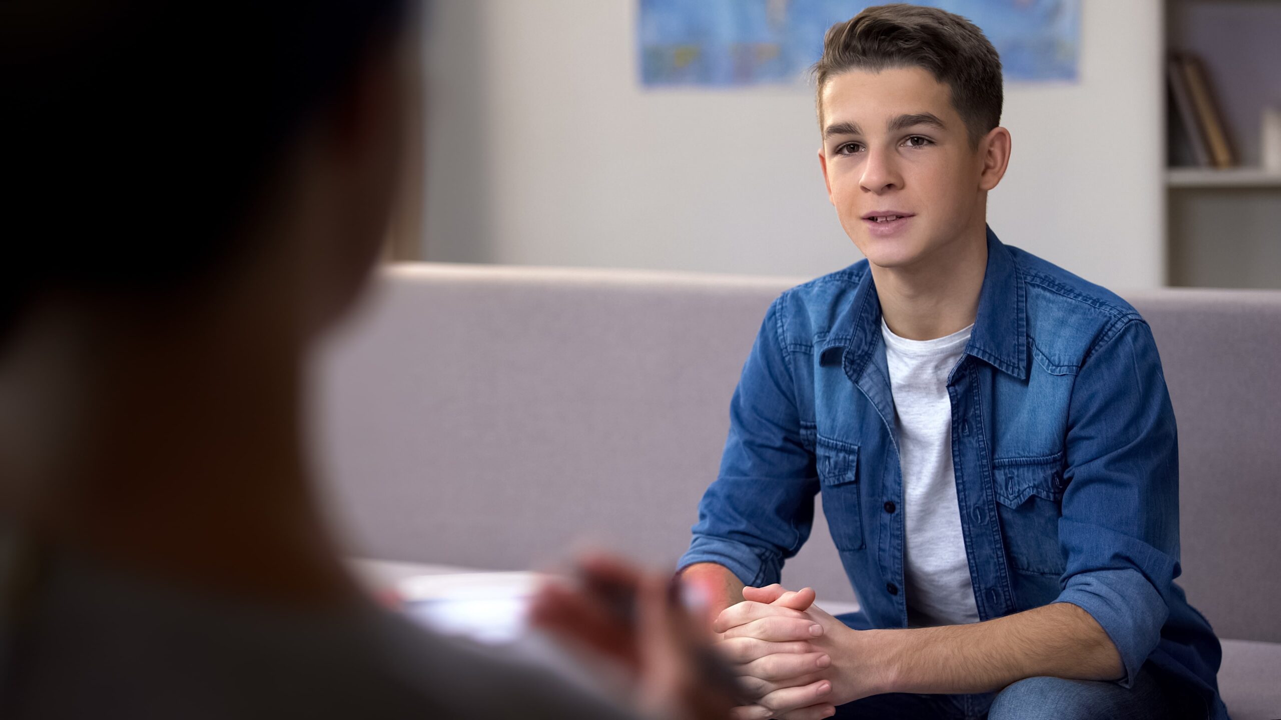 A teen talking with a counselor