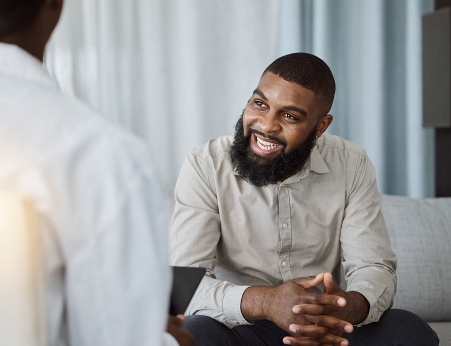 A man smiling during a counseling conversation