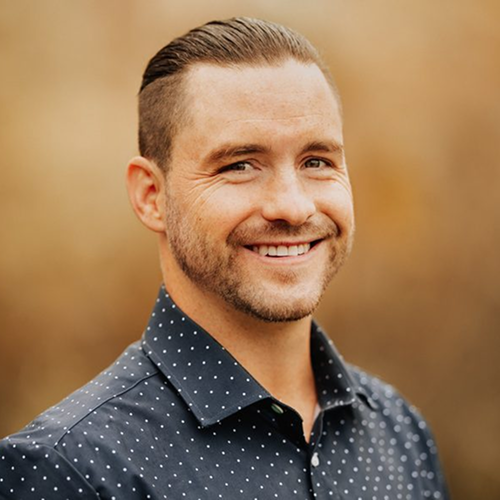 Colbey Strong smiling in a black patterned shirt