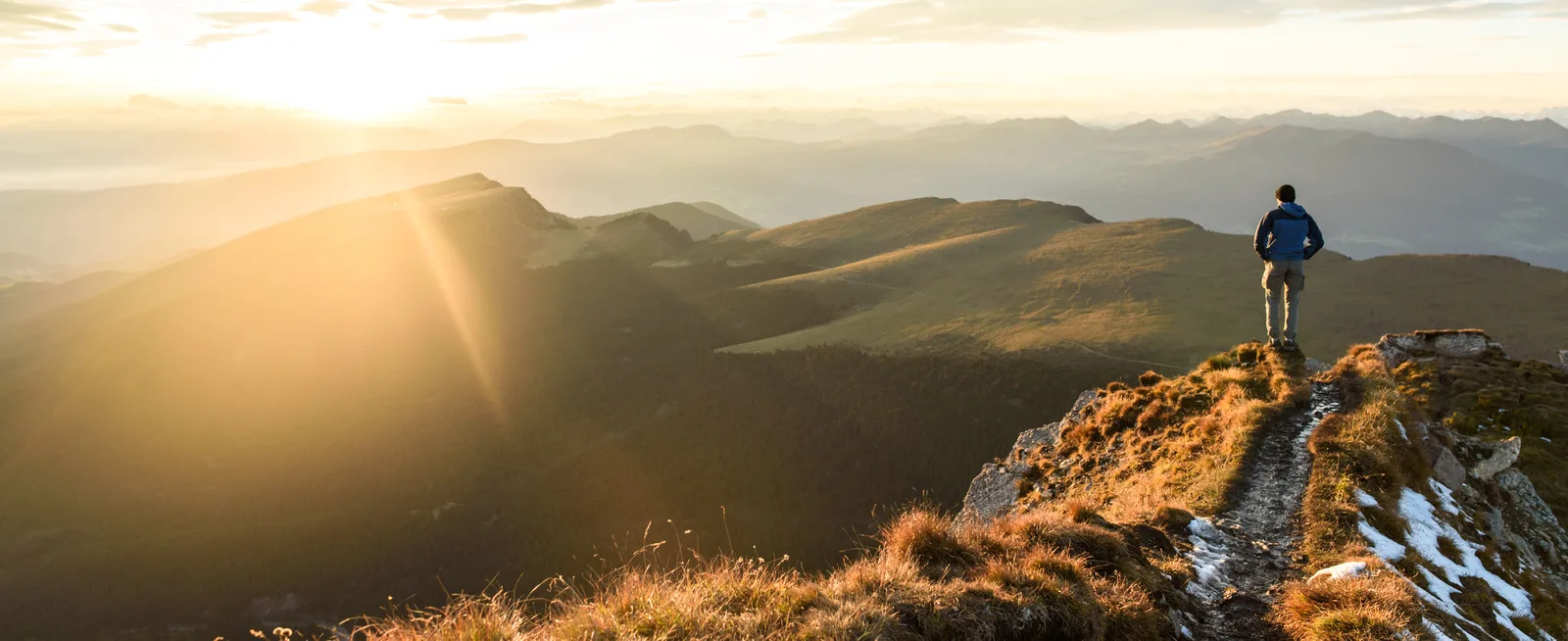 A person walking along a mountain trail