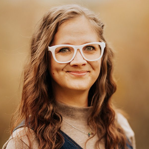 Mary Newman smiling in a light sweater