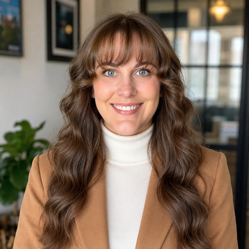 Michelle Lancaster smiling in a tan blazer