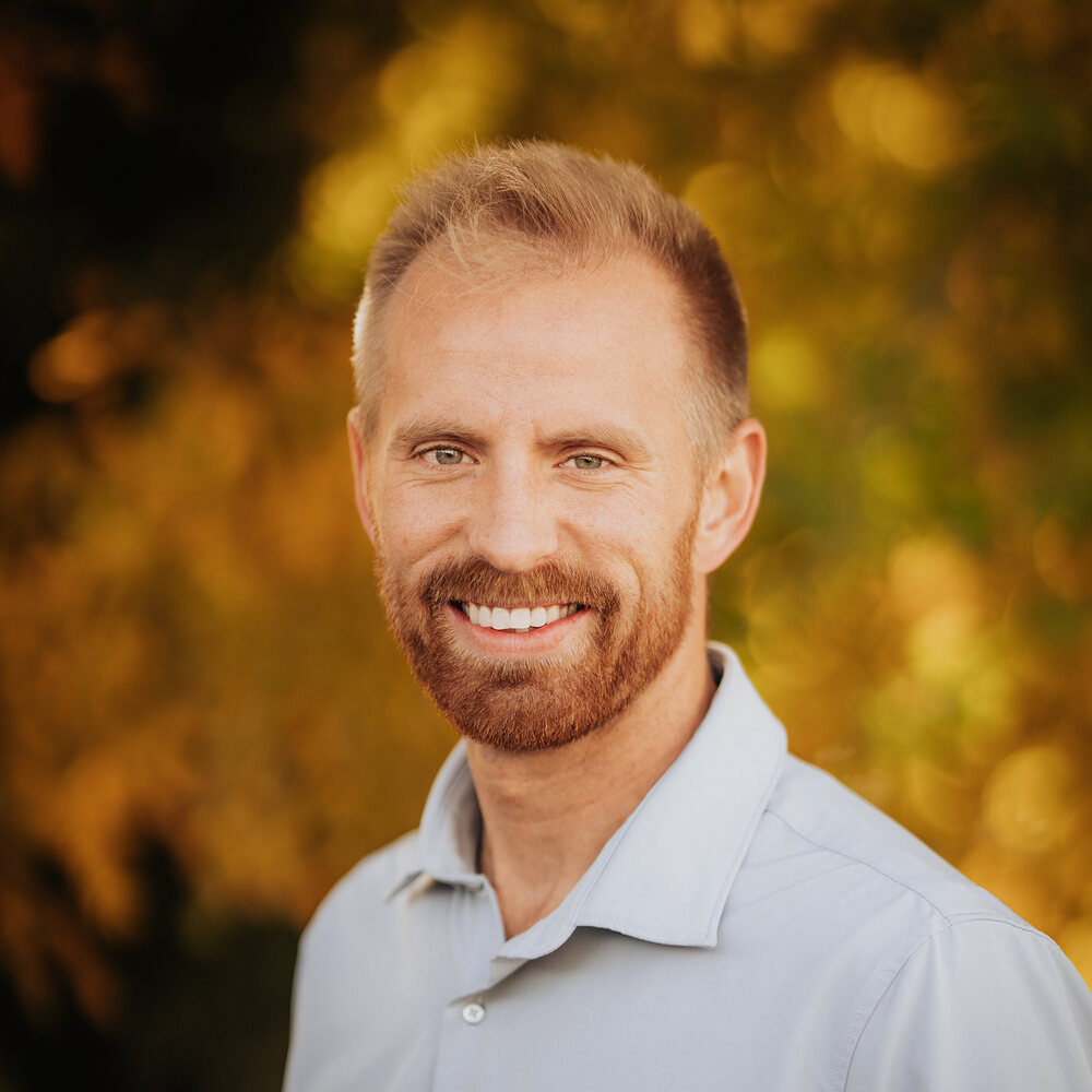 Parker Hudson smiling in a light blue shirt