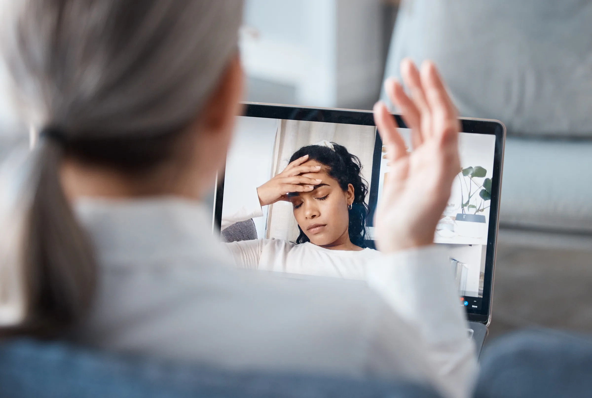 A woman participating in a video counseling conversation from home